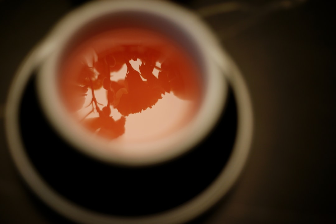 Hand holding a coffee cup — a common cause of staining that shortens whitening results